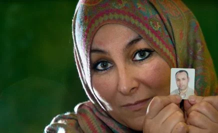 Farida Aarrass holding a picture of her brother