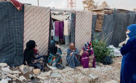 Four woman sitting in a refugee camp in Lebanon