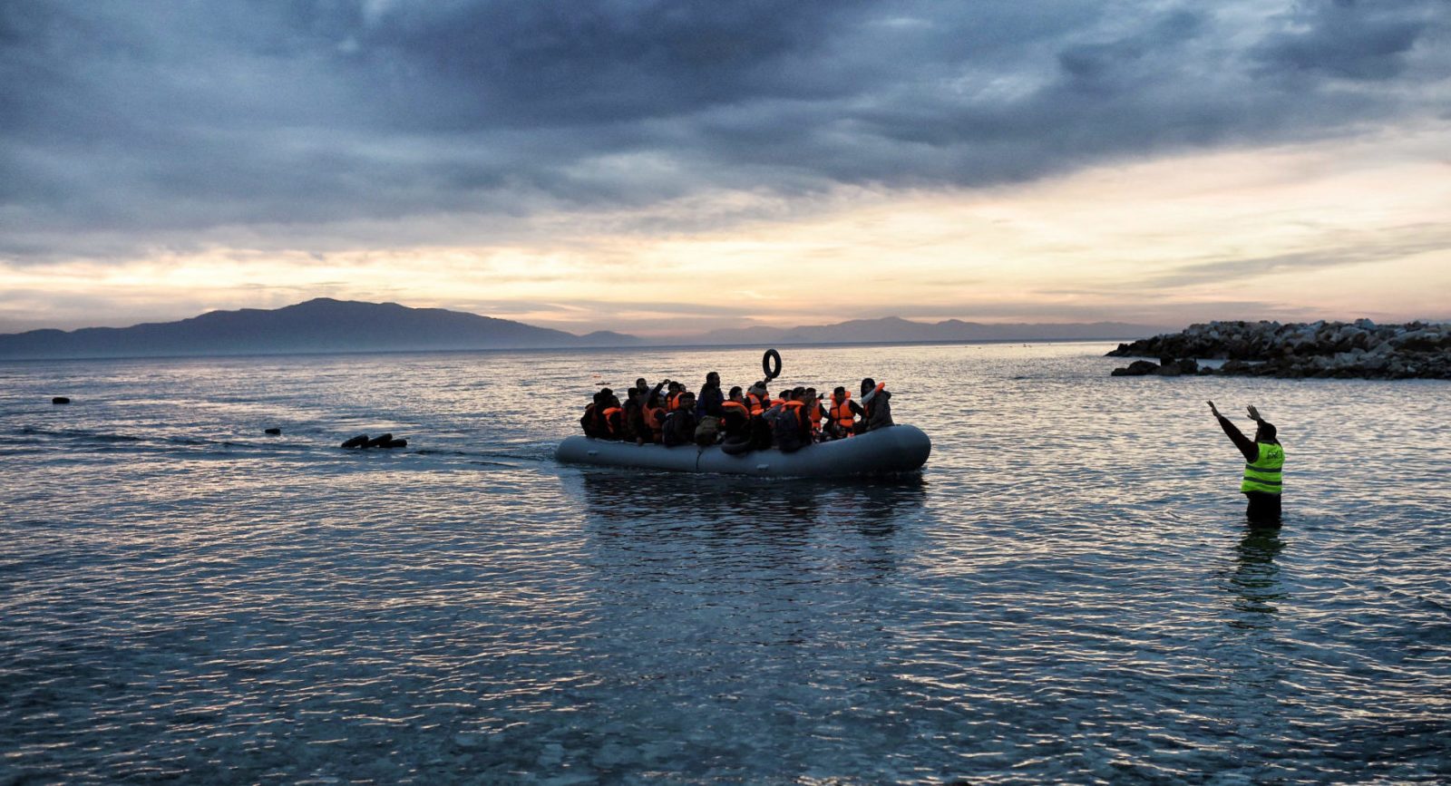 Refugees and migrants on an inflatable boat arrive in Greece.