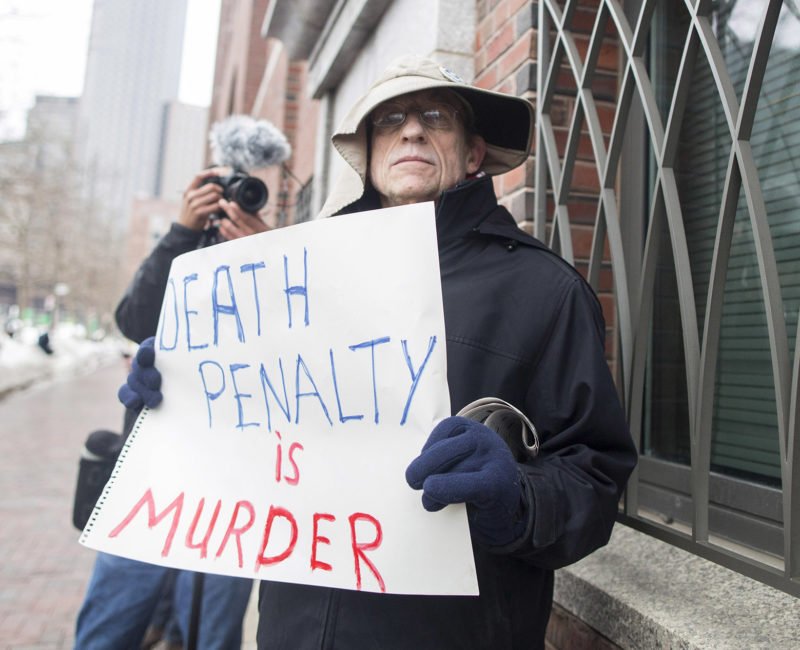 © Getty images. Protester holds a sign that reads