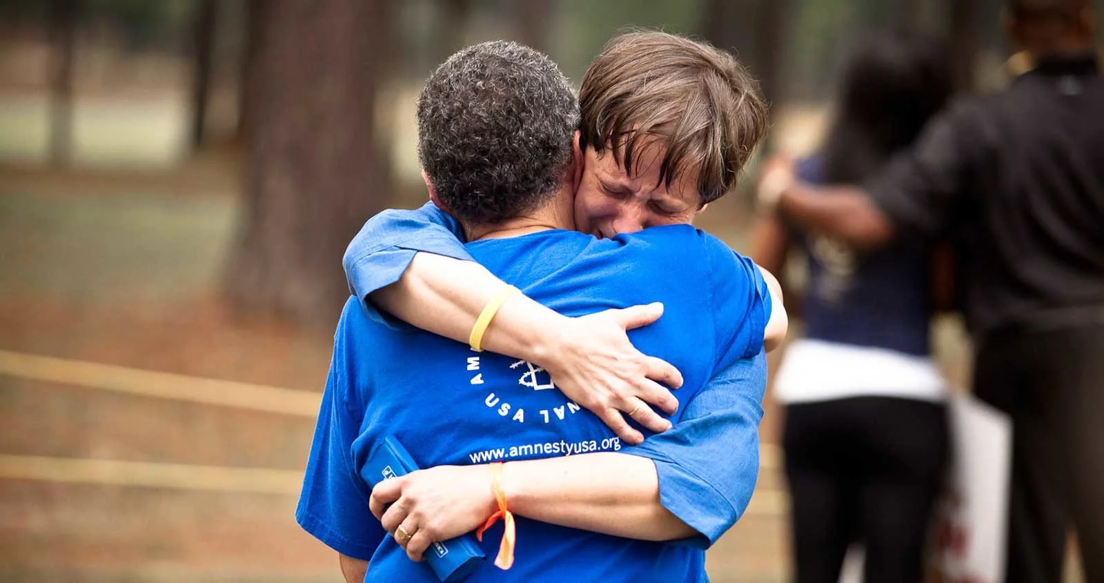 Two people hug at a vigil in Jackson