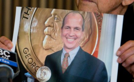 Juris Greste displays a picture of his son, Peter Greste, next to his wife Lois during a press conference in Brisbane on June 24, 2014.