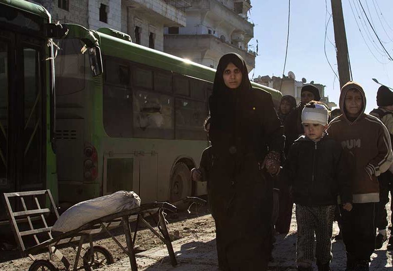 Syrians gather during an evacuation operation of rebel fighters and their families from rebel-held neighbourhoods