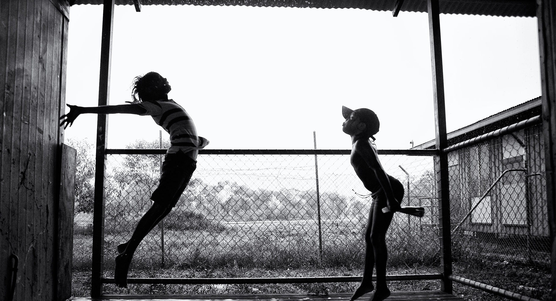© Ingetje Tadros / AI. Two young Indigenous children playing on a verandah