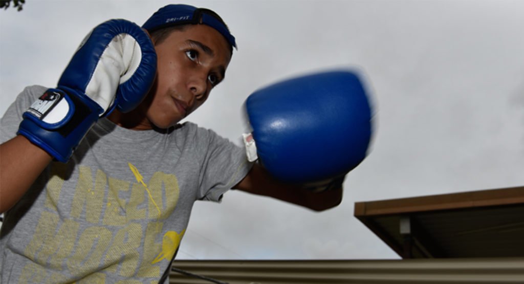 12-year-old Wayne Parker Junior loves boxing with his grandad. © Wayne Quilliam