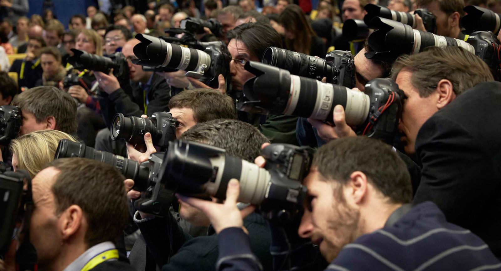 A group of professional photographers holding cameras.