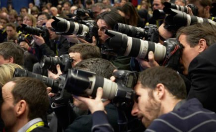 A group of professional photographers holding cameras.