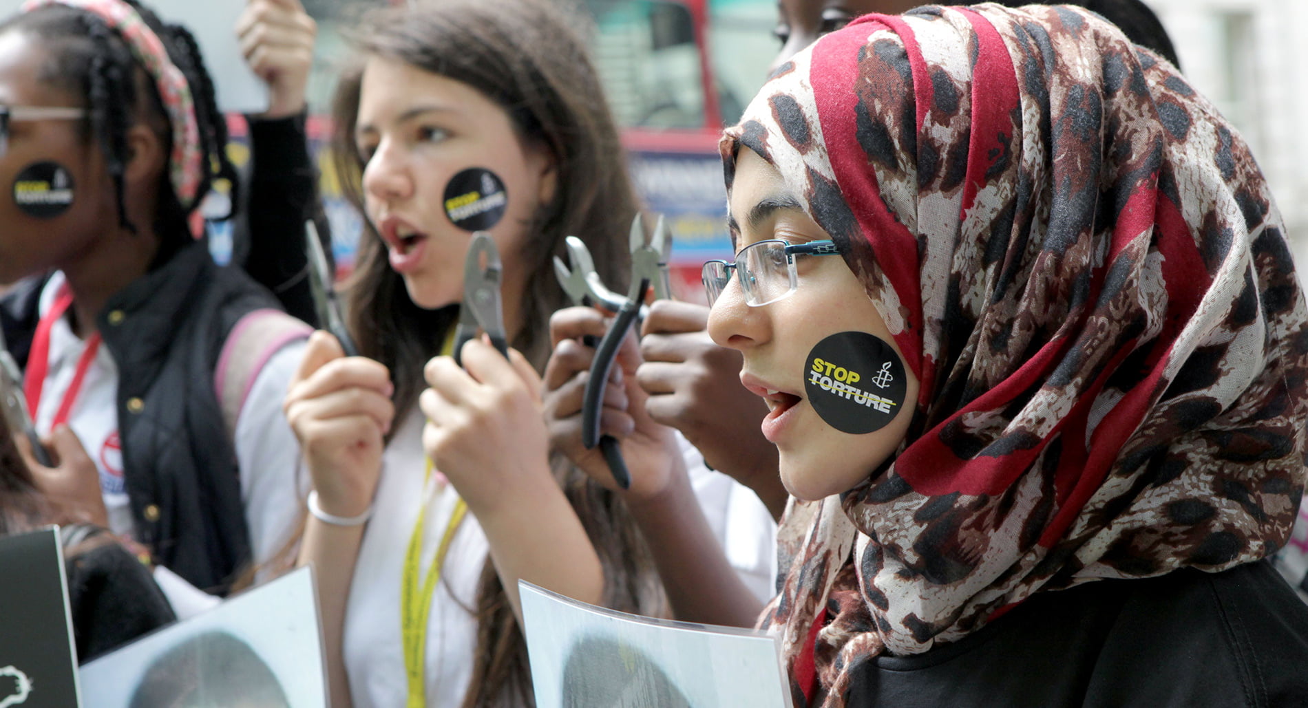 Amnesty activists outside the Nigeria High Commission holding bolt cutters