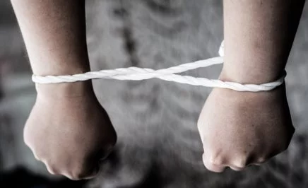 Arms bound by rope