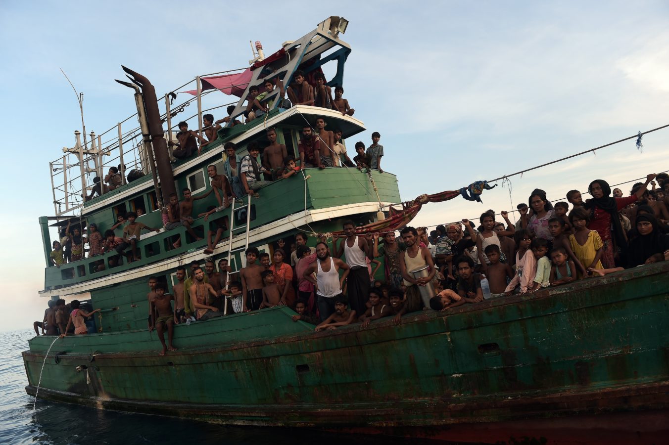 Rohingya migrants sit and stand on a boat drifting in Thai waters off the southern island of Koh Lipe in the Andaman sea on May 14, 2015. A boat crammed with scores of Rohingya migrants -- including many young children -- was found drifting in Thai waters on May 14, with passengers saying several people had died over the last few days.