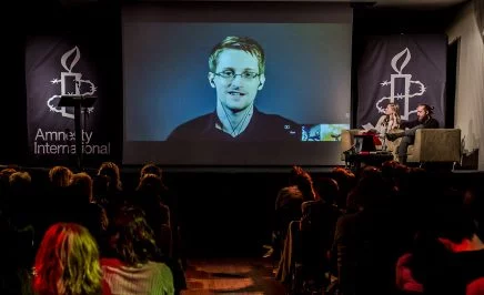 Edward Snowden appearing via video link at an Amnesty International event