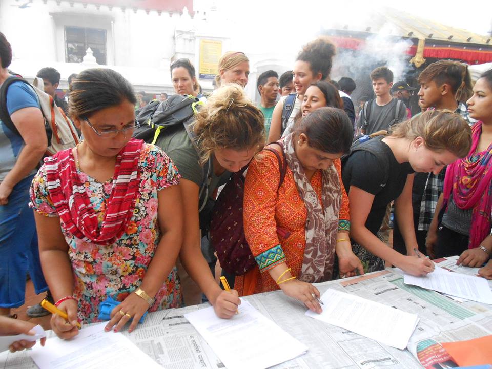 Amnesty supporters line up to sign petitions in support of victims of torture.