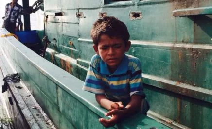 Rohingya child on boat at sea
