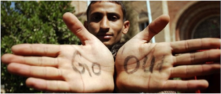 A man holding out his hand. The words 'go' and 'out' are written on his palms