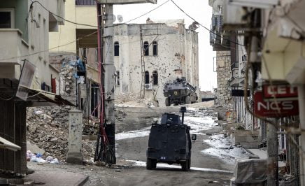 Military vehicles move a deserted street in southerneastern Turkey following clashes between Turkish forces and Kurdish militants on November 10, 2015.