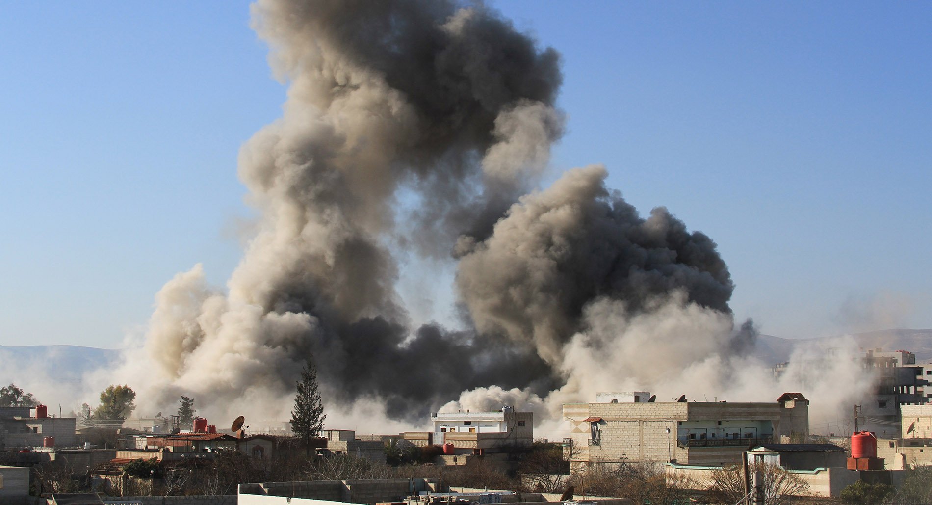 Smoke rising after a barrel bomb attack in Daraya, Syria
