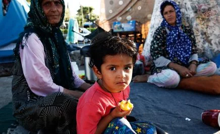 A young Afghan boy and his family who have been living in the old airport of Elliniko, Athens for five months