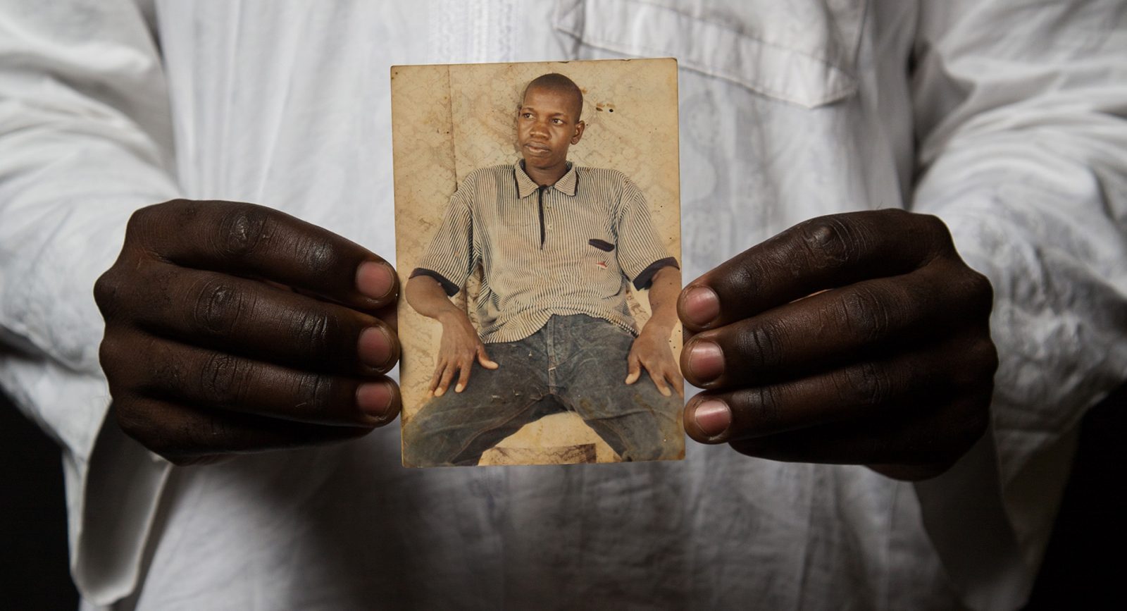 A man holds a photograph