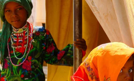 Two young girls in colourful traditional dress