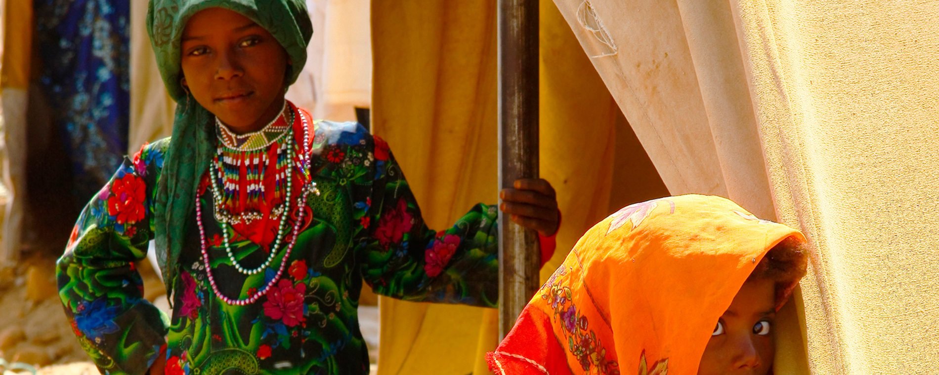 Two young girls in colourful traditional dress