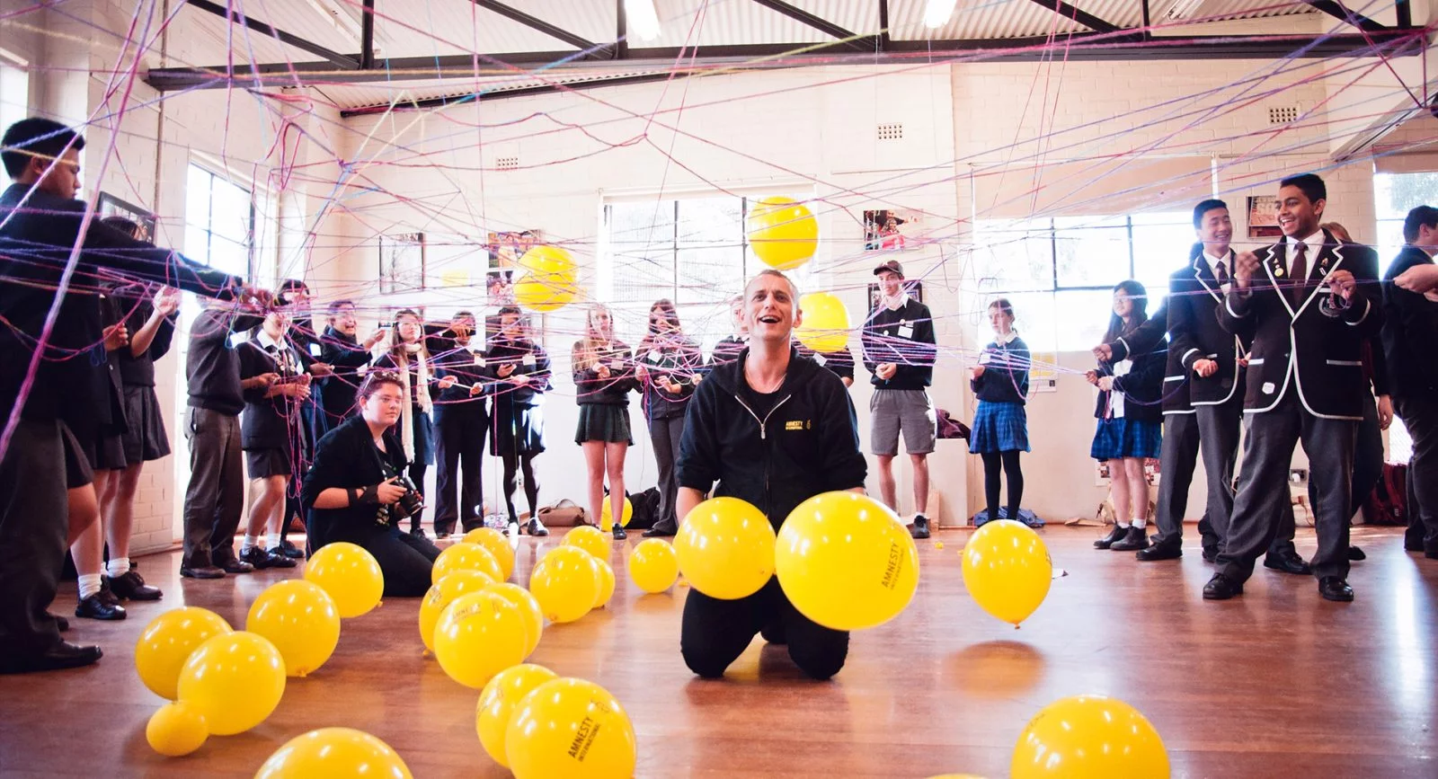 An activist and children at the Amnesty NSW schools conference