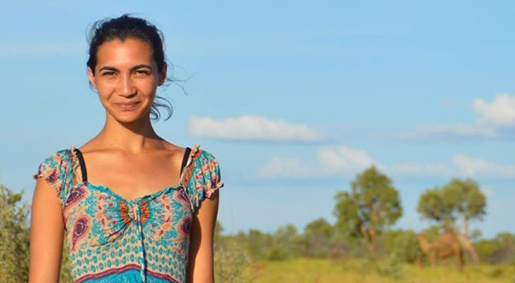 Woman standing with trees in background