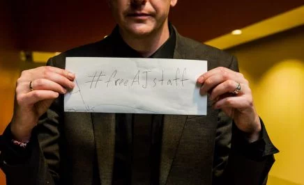 Man holding sign that reads 