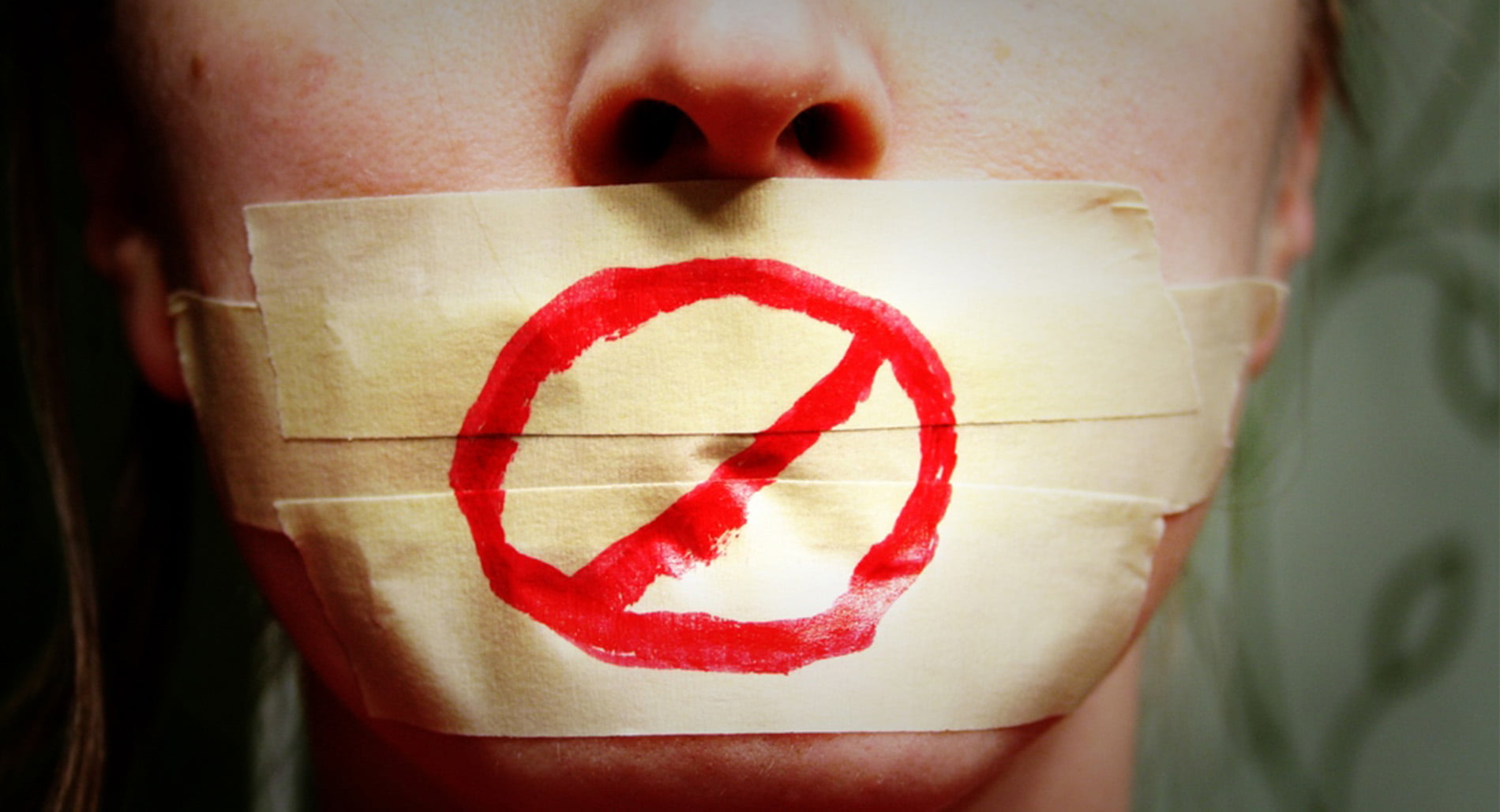 A woman with tape over her mouth