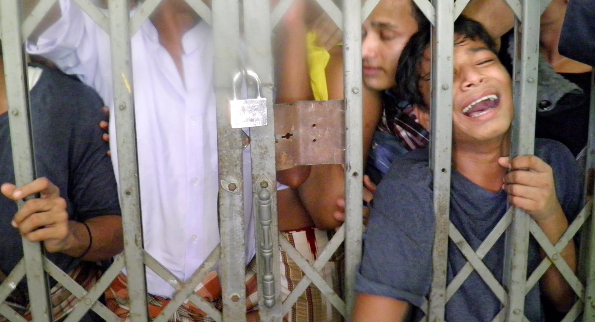 Boy behind bars in a detention center