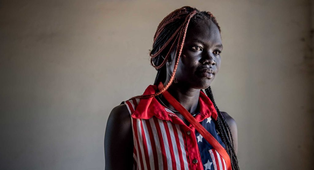 A young refugee with an American flag shirt,