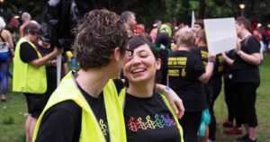 Two women with rainbows painted on their cheeks