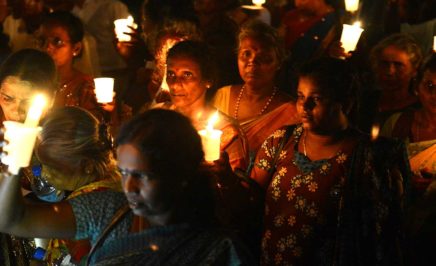 Sri Lankan activists hold lighted candles during a candlelight vigil in Colombo