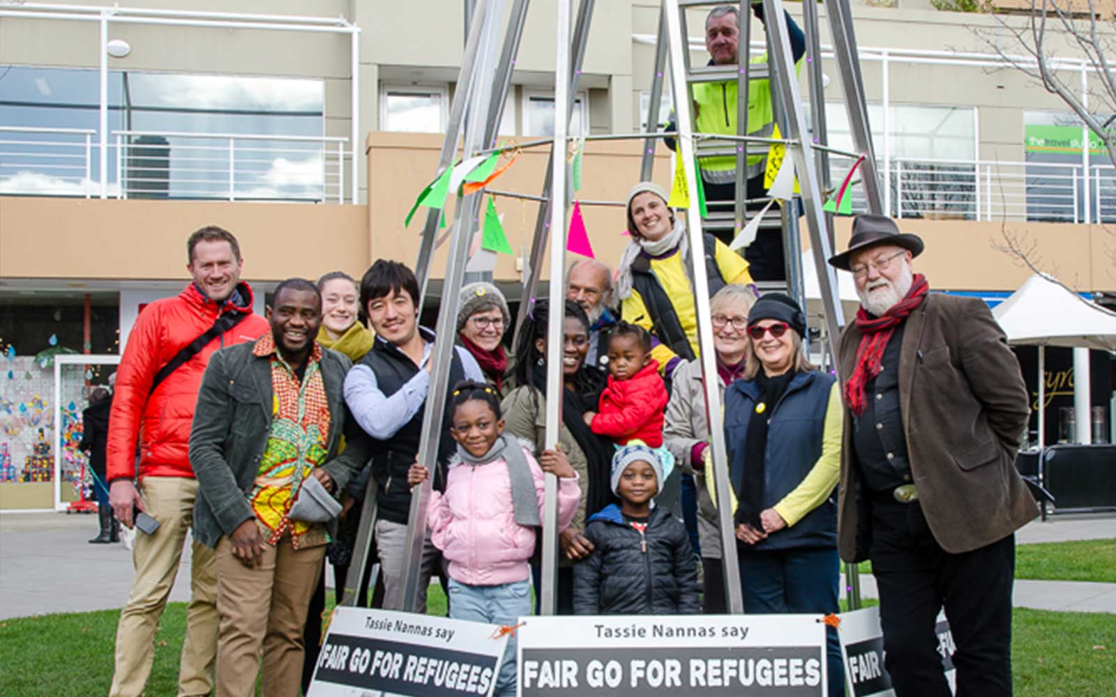 The Tasmanian Refuegee Group, volunteers and members of the public in front of the Welcome Refugee Tree