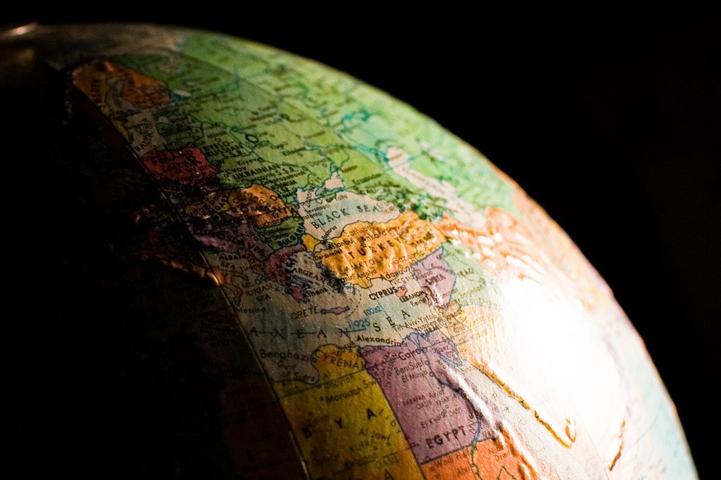 A close up photo of a globe set against a black background