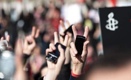 Protestors hands holding mobile phones