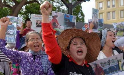 Cambodian land rights activists shout slogans during a protest in front of the Phnom Penh municipal court on August 22, 2016 to demand the release of two prominent activists who were sentenced to six days in jail.