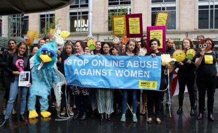 Amnesty staff and activists with banners and props targeting Twitter on online abuse of women