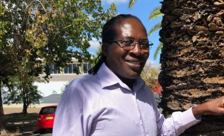 Felix Machiridza smiling next to a tree