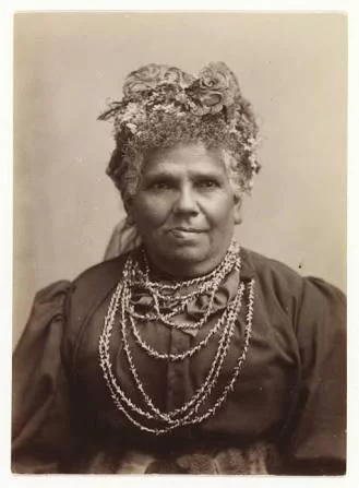Sepia vintage photo of Fanny Cochrane Smith, Fanny Cochrane Smith wearing wattle in her hair and traditional shell necklace.