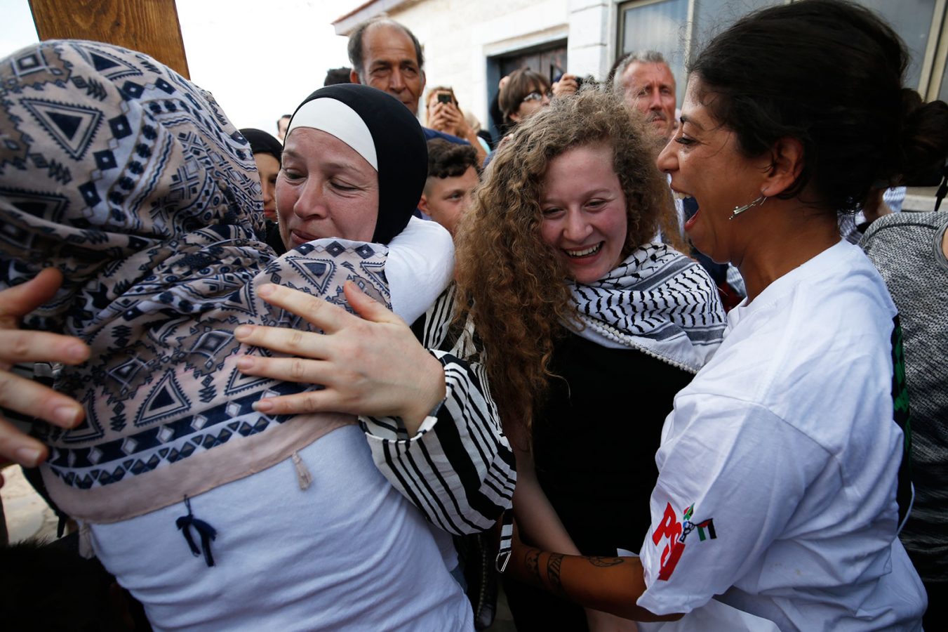 Ahed Tamimi greeting friends with her mother following her release from prison in the West Bank