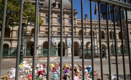 146 stuffed toys behind bars out the front of Queensland Parliament House. For each teddy there is a child under 14 behind bars in Queensland
