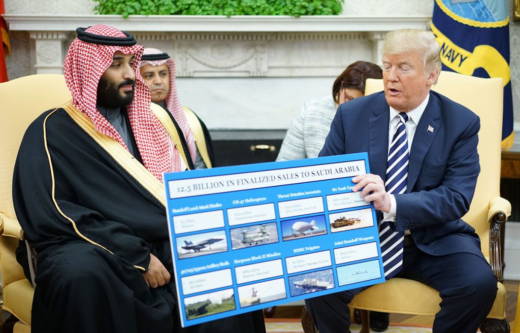 US President Donald Trump holds a defence sales chart with Saudi Arabia's Crown Prince Mohammed bin Salman in the Oval Office of the White House on 20 March 2018 in Washington DC.