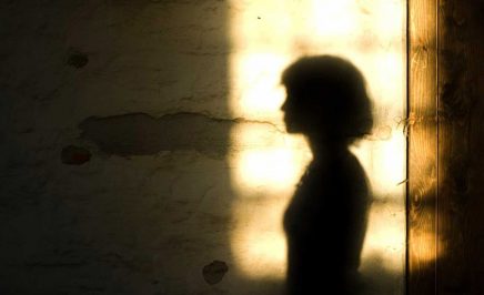 The silhouette of a women against light background.