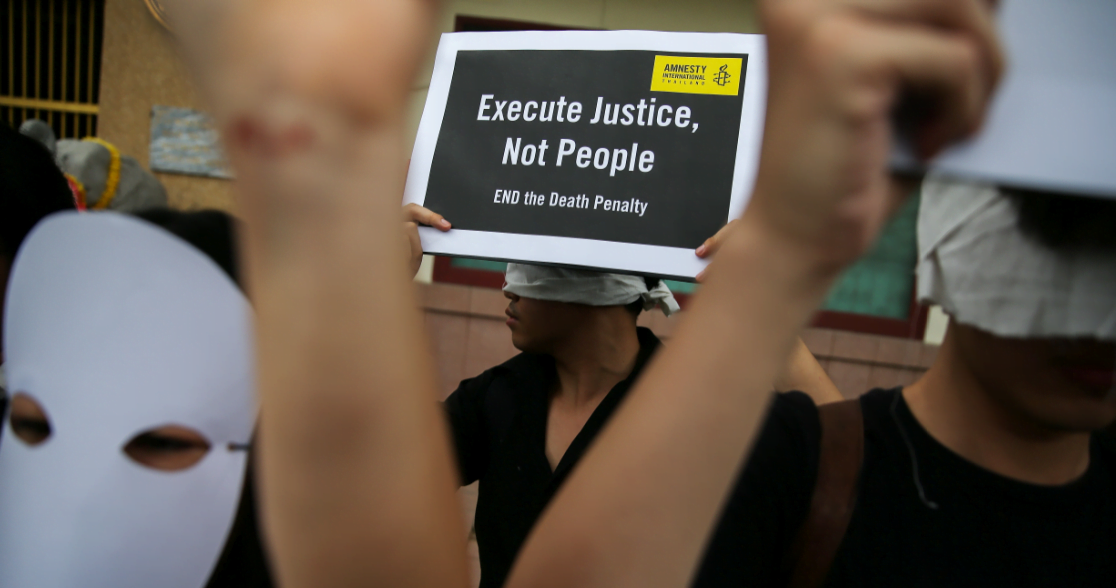 Demonstrators from Amnesty International hold placards outside the Bang Kwang Central Prison to protest against the death penalty in Bangkok, Thailand, June 19, 2018.