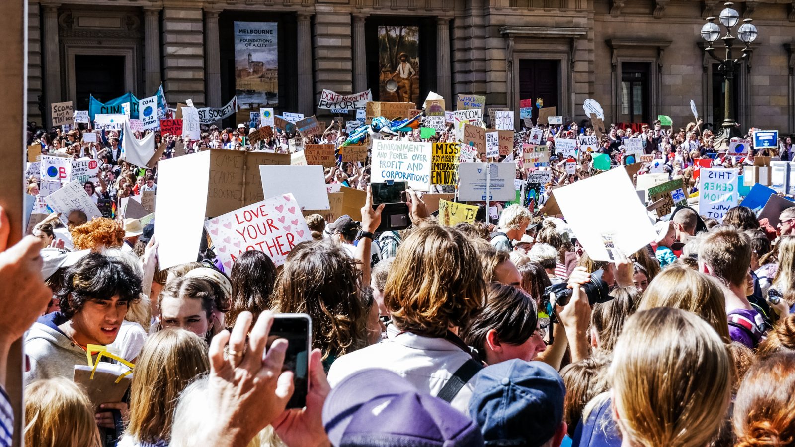 A group of people gathered holding signs for climate action