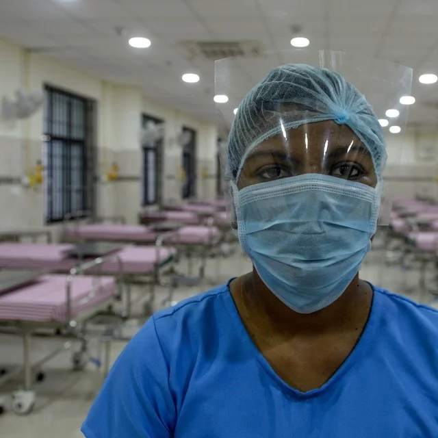 A medical staff wearing a facemask poses in an isolation ward at a newly inaugurated hospital by the Tamil Nadu state during a government-imposed nationwide lockdown as a preventive measure against the COVID-19 coronavirus, in Chennai on March 27, 2020.