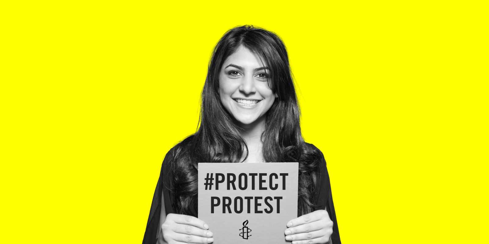 Protect the protest image of young woman smiling at the camera