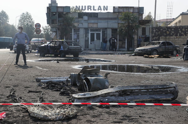 Vehicles damaged in the 28 October 2020 shelling attack in a street. The fighting between Armenia and Azerbaijan over Nagorno-Karabakh resumed in late September with both countries accusing each other of provocation, declaring martial law, and mobilising their armed forces