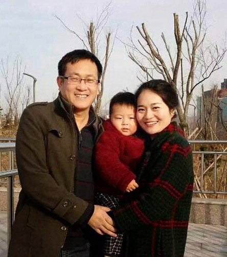 Wang Quanzhang and his family smile for a photo