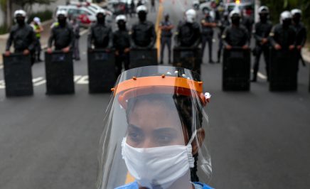 A resident of Paraisopolis, one of the city's largest slums, takes part in a protest in Sao Paulo, Brazil, on May 18, 2020, to demand more aid from Sao Paulo's state government during the COVID-19 coronavirus pandemic.